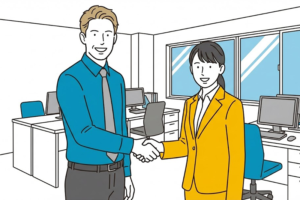 外国人スタッフと日本人担当者が笑顔で握手をしているオフィスの風景